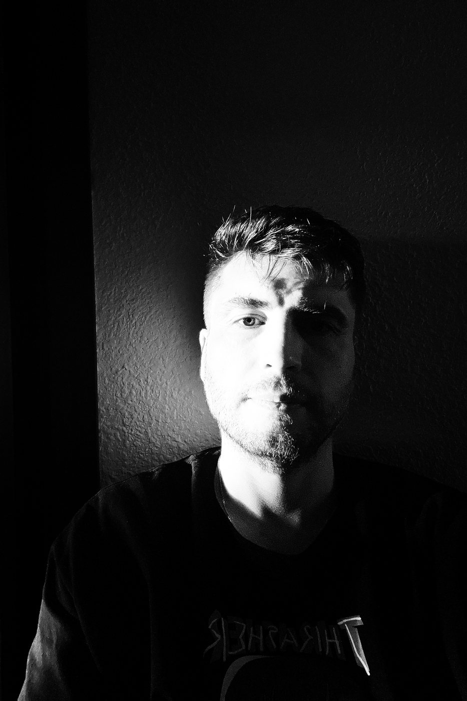 Black and white portrait of Ivan Uralsky, half of his face in light