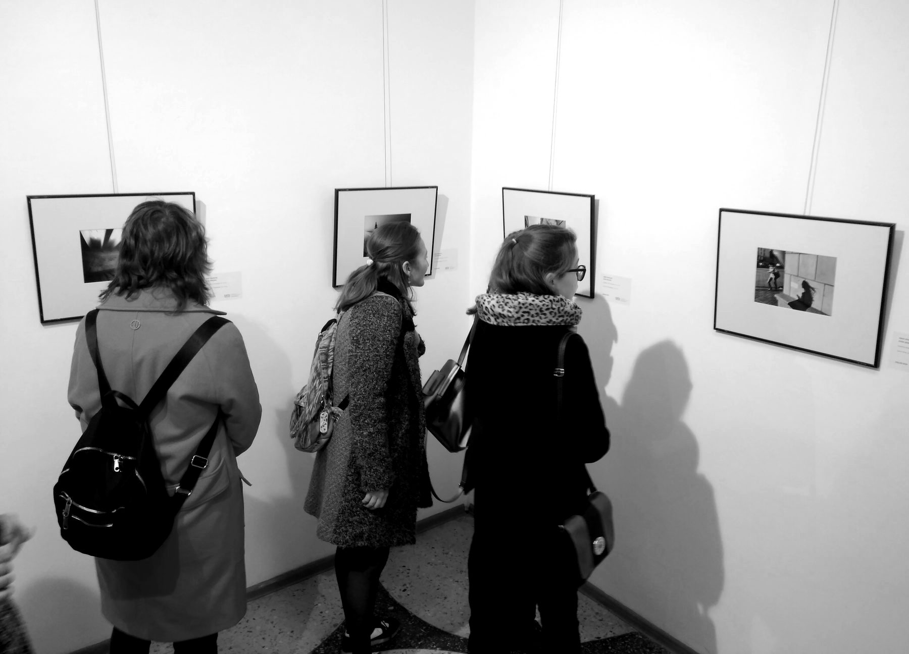 Visitors looking at Ivan Uralsky's prints at the Autumn Salon 2018